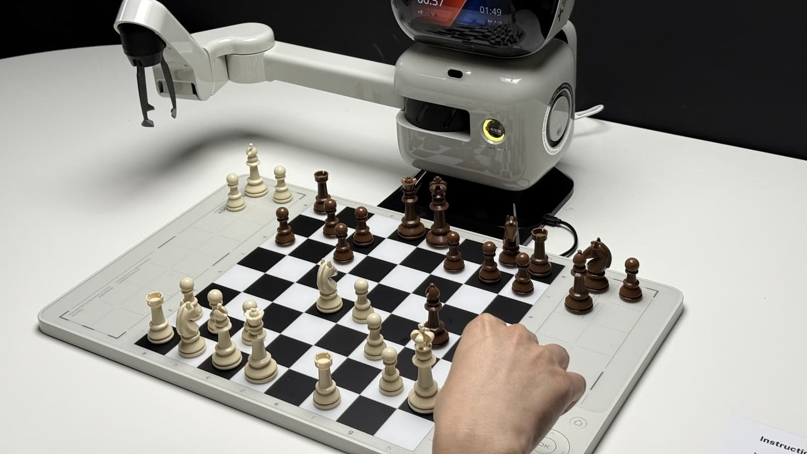 Robot arm playing chess against a human opponent, representing reinforcement learning research